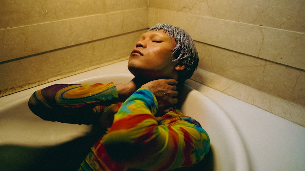 a person laying down in a bath tub