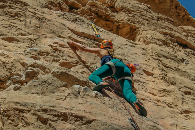 a man climbing up the side of a mountain