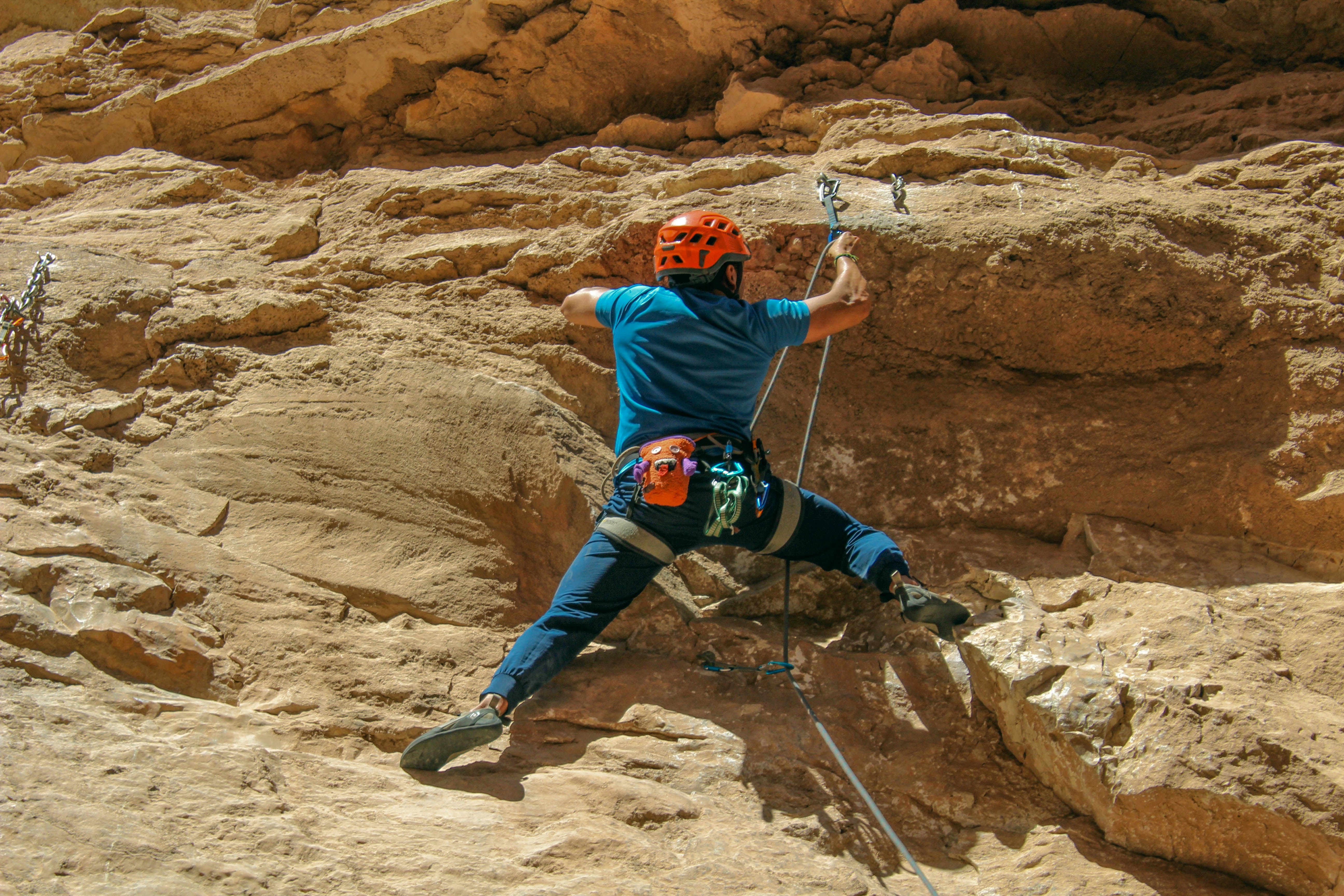 a man climbing up the side of a mountain