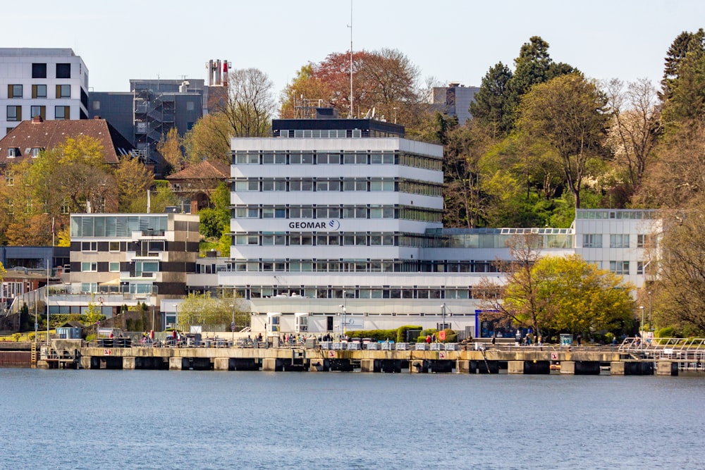 a large white building sitting next to a body of water