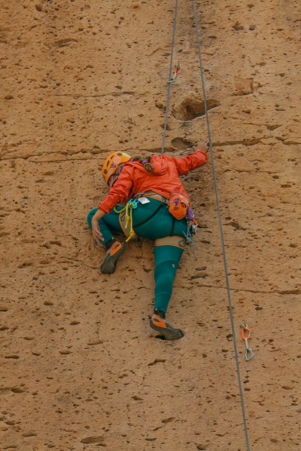 a man climbing up the side of a mountain