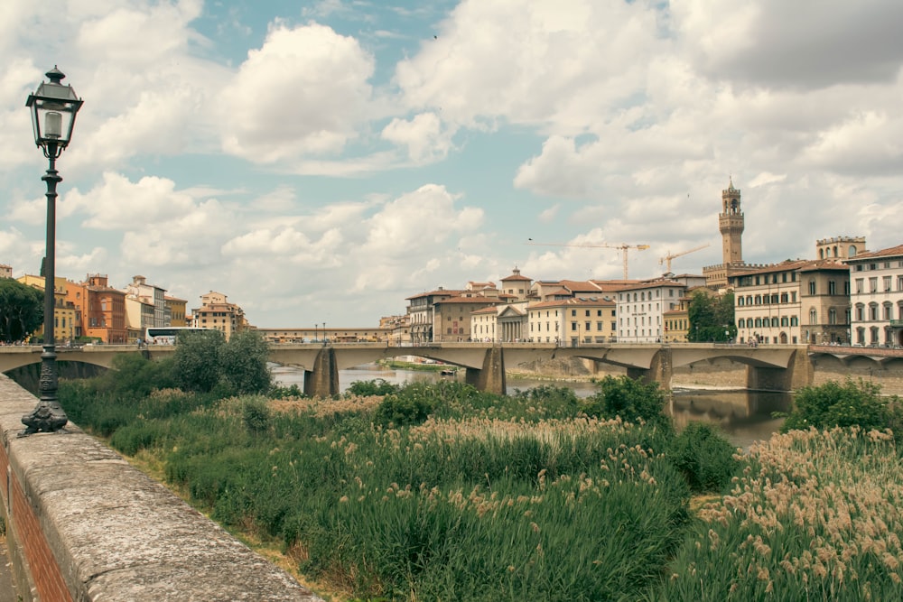 a view of a bridge over a river with buildings in the background