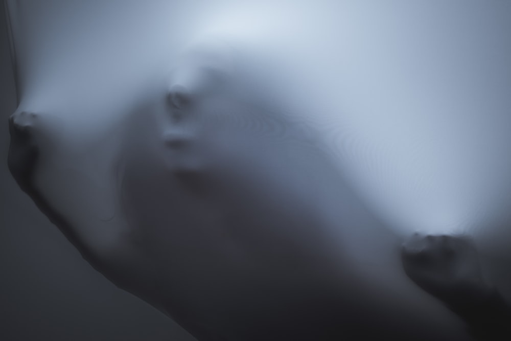a blurry photo of a person's face and arm