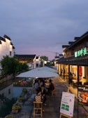 Guests enjoying a flavorful local lunch at a cozy Zhujiajiao riverside restaurant.