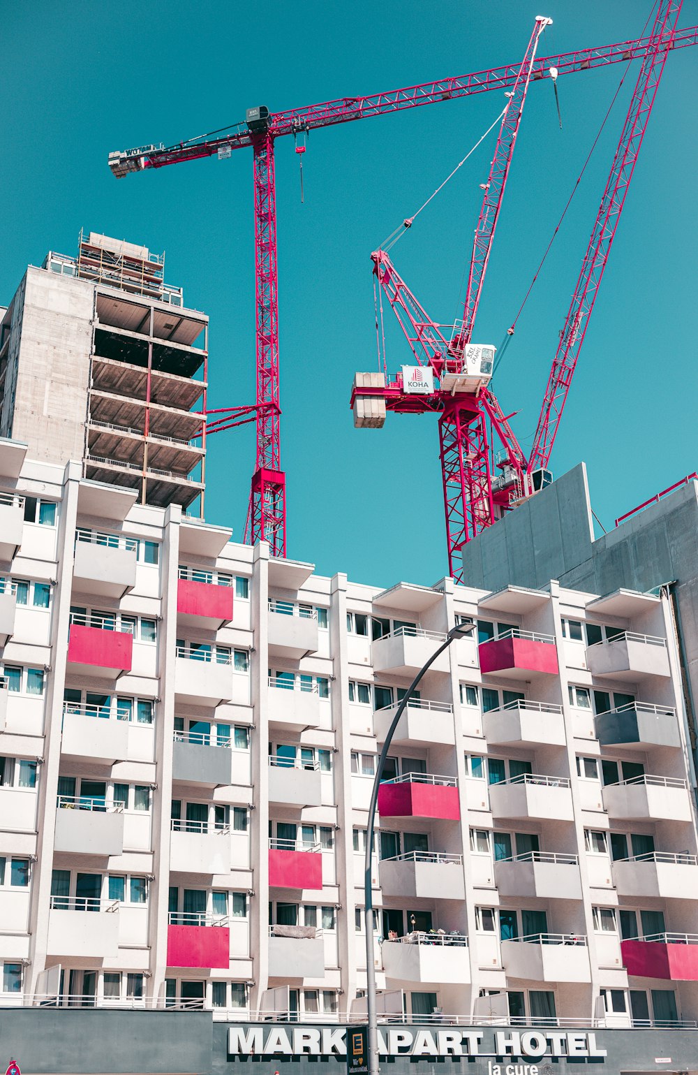 a crane is standing in front of a building under construction