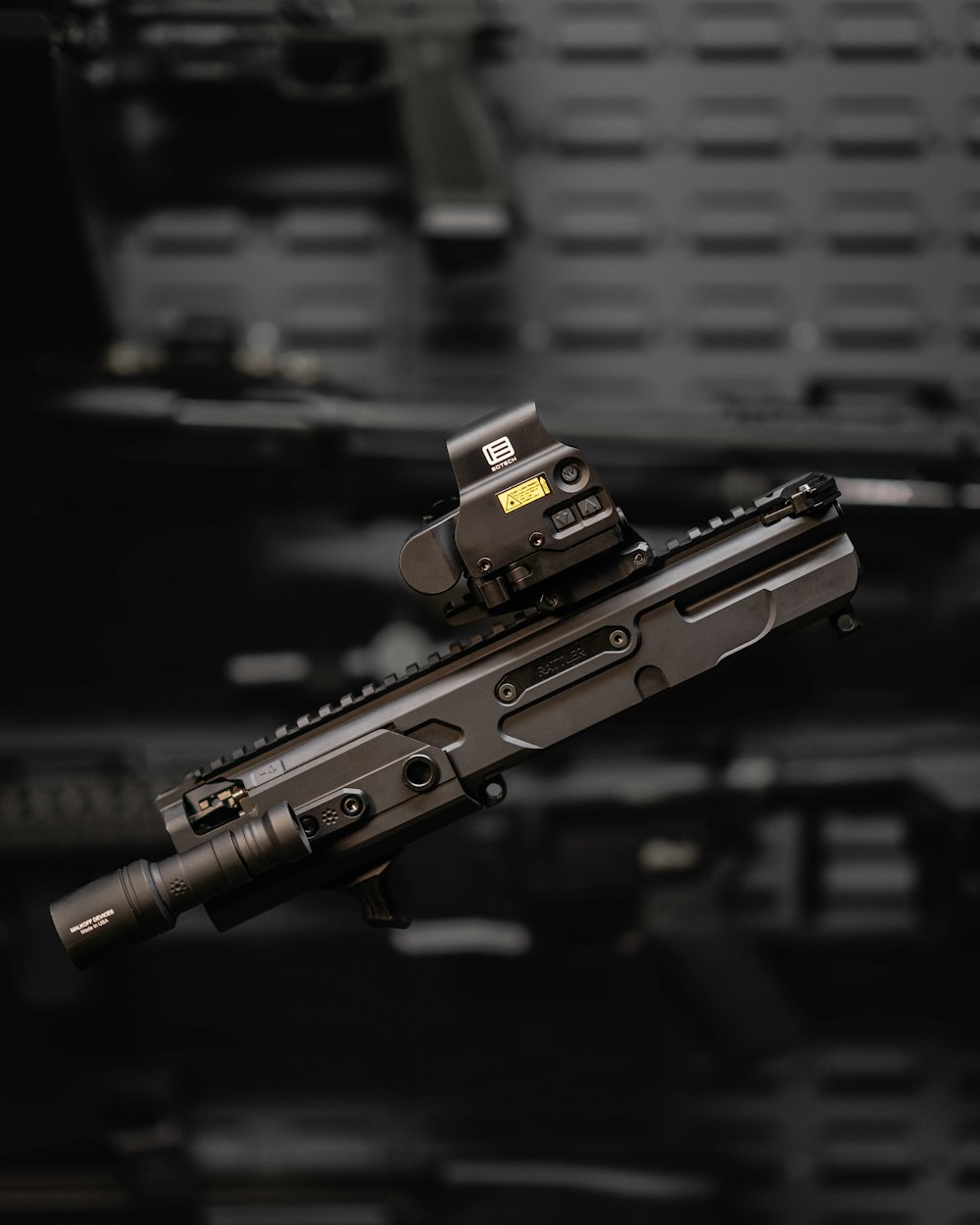 a close up of a rifle on a black background