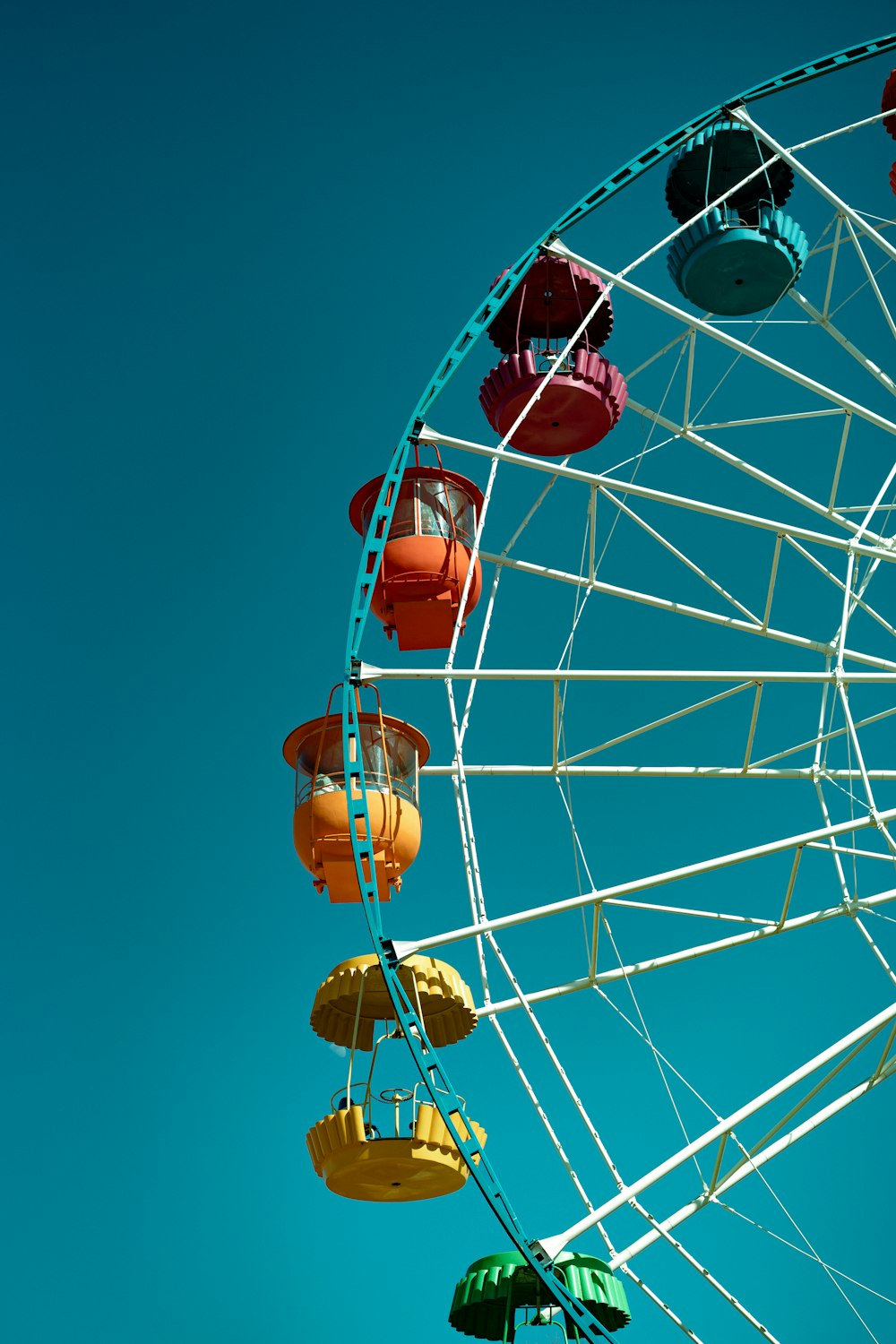 a large ferris wheel with colorful decorations hanging from it's sides