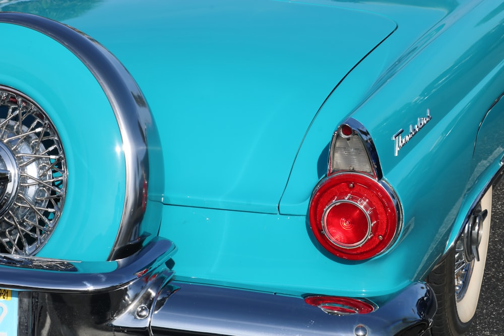 a close up of a blue car with chrome rims