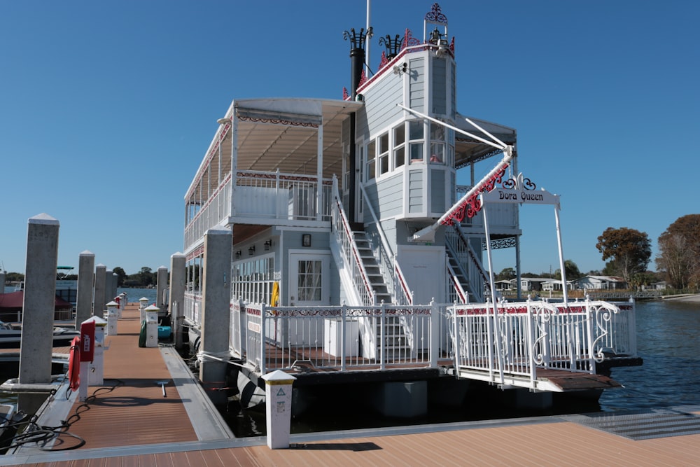 a white house sitting on top of a wooden pier