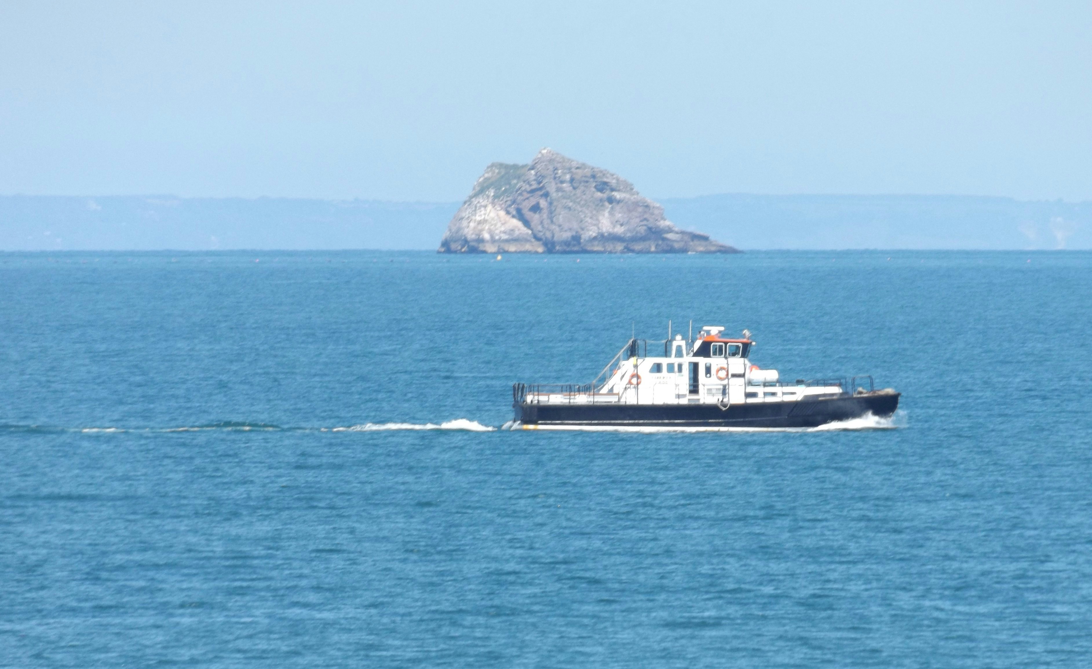 a small boat traveling across a large body of water