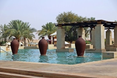 a pool with a few large vases in it