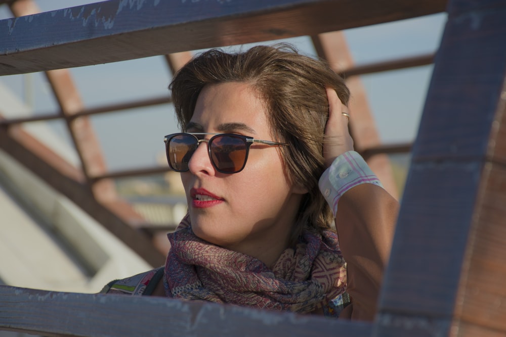 a woman wearing sunglasses and a scarf