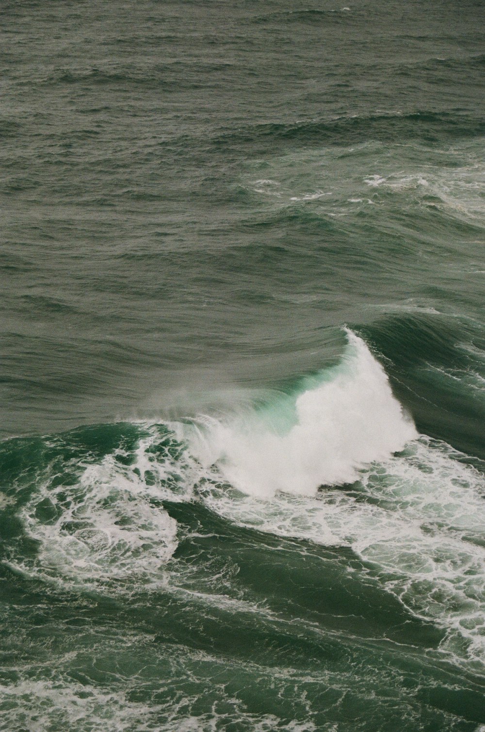 a man riding a wave on top of a surfboard