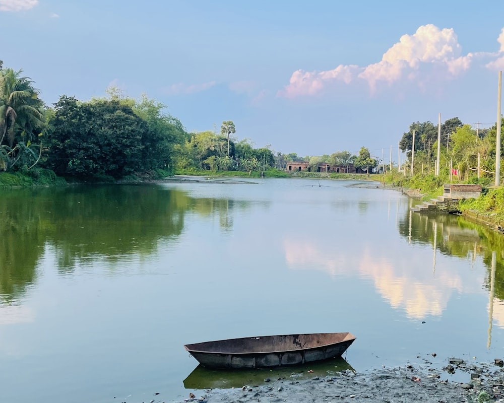 a small boat floating on top of a lake