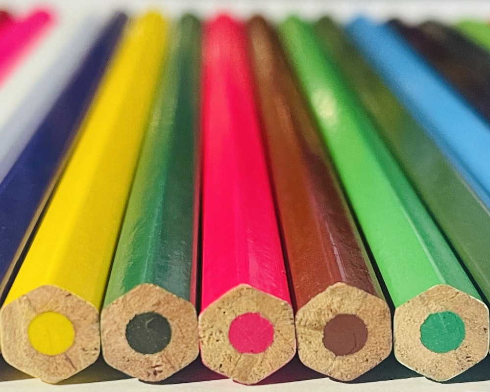 a close up of a row of colored pencils