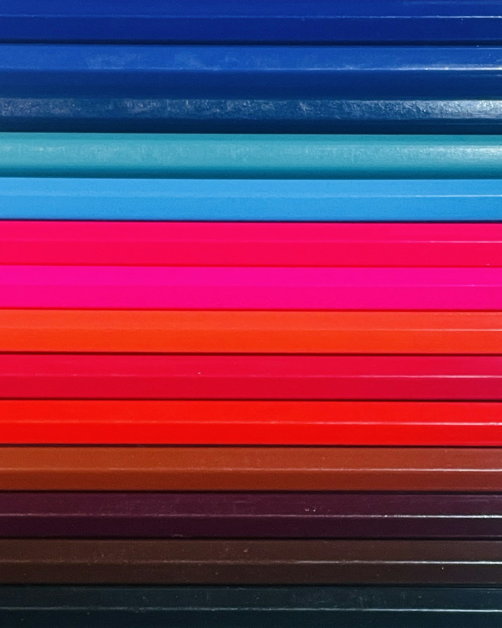 a stack of colored pencils sitting on top of each other