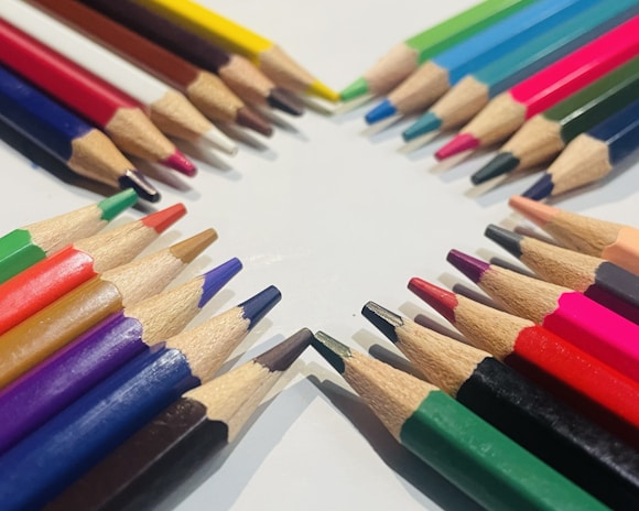 An array of no point pencils in various colors neatly arranged on a white background.