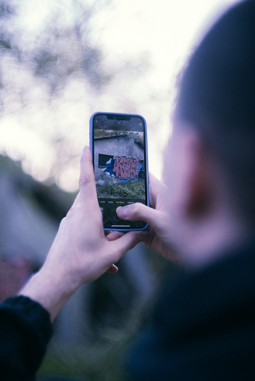 a person taking a picture with a cell phone