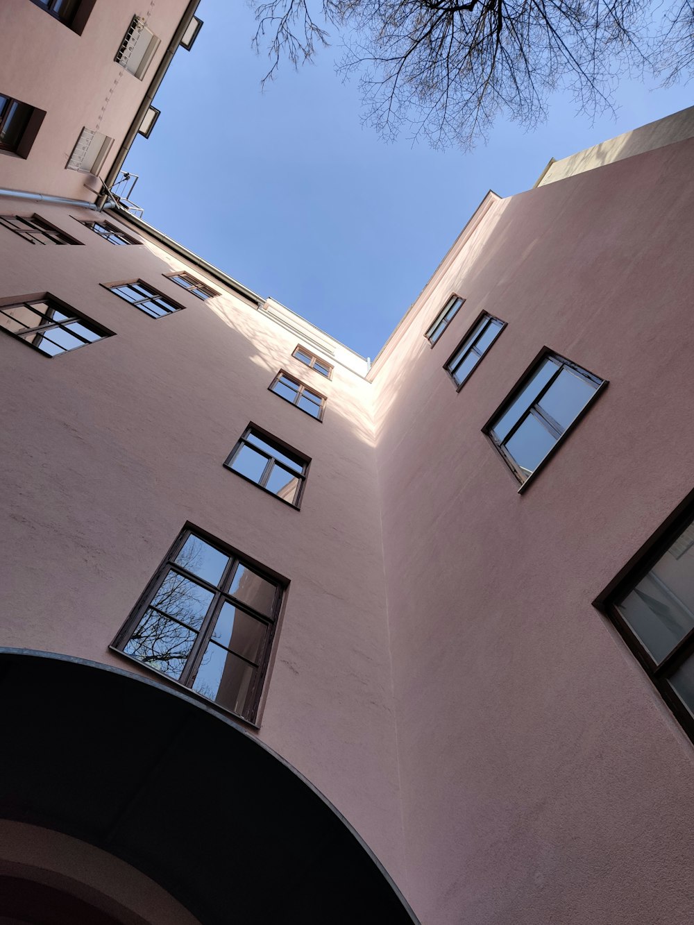 looking up at a tall building with many windows