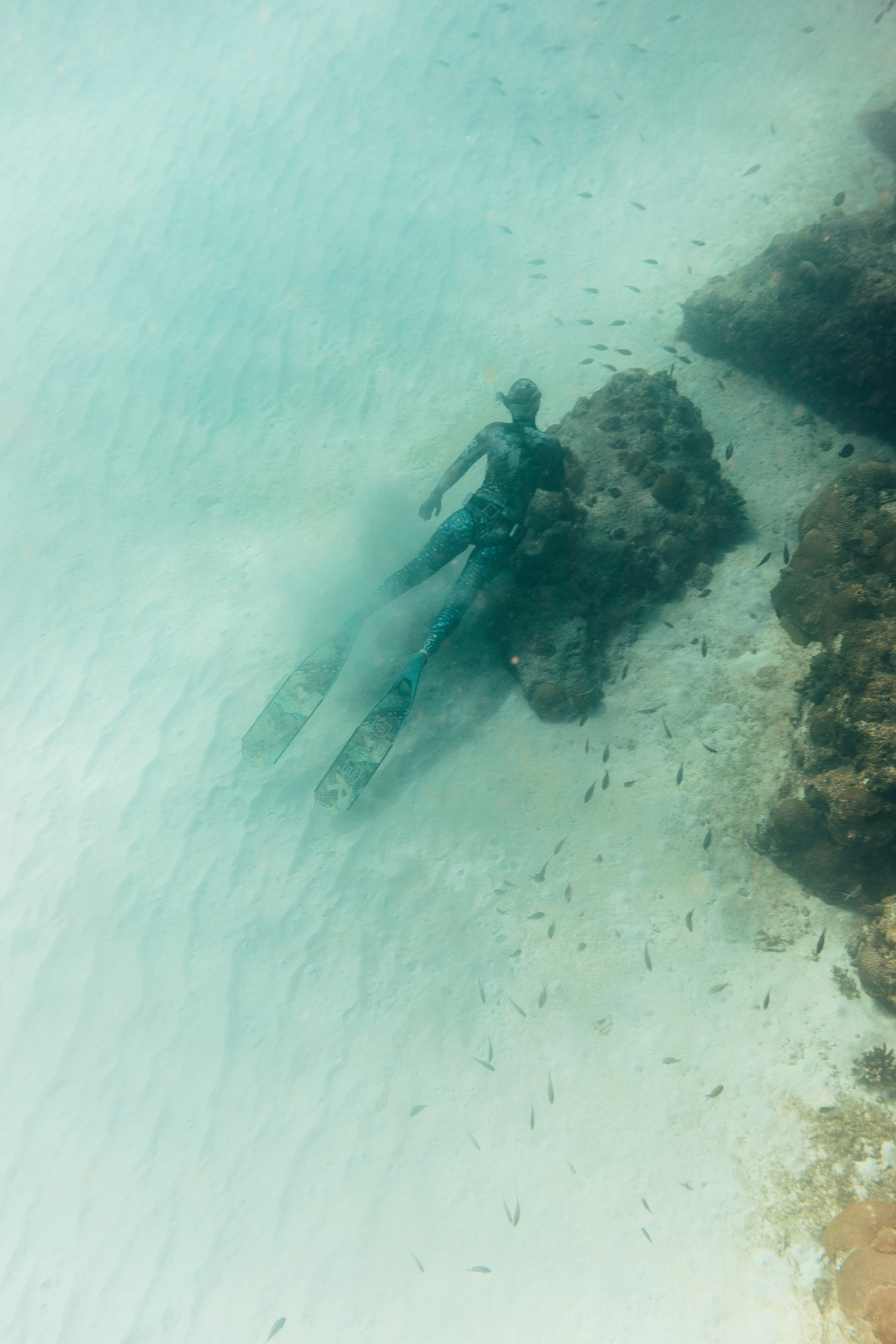 a person on skis in the water near rocks