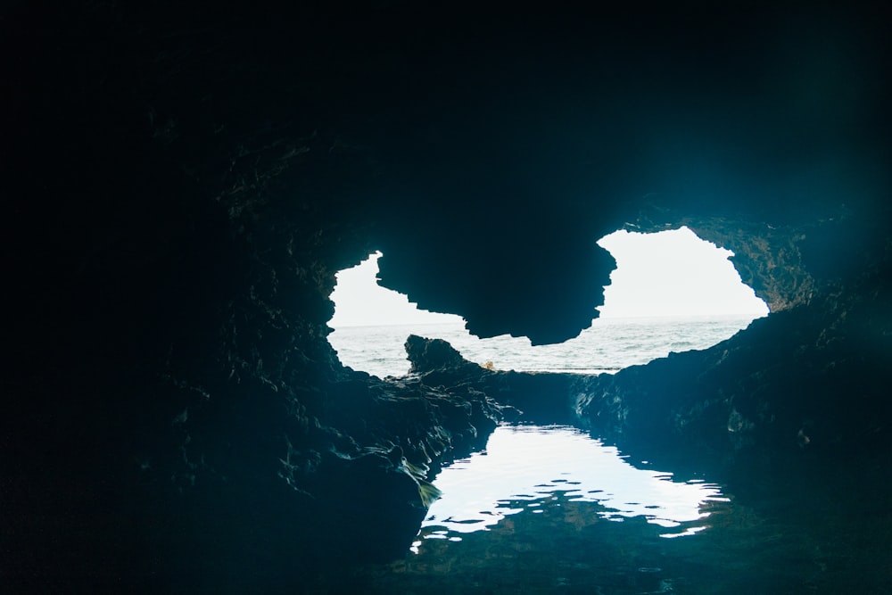 a view of a body of water from inside a cave
