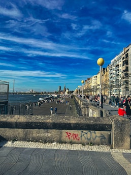 Tourists enjoying a walk along Petrolina’s riverfront promenade near historical landmarks.