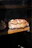Close-up of a rustic artisan bread loaf with a warm, natural light highlighting its texture.