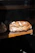 Close-up of a rustic artisan bread loaf with a warm, natural light highlighting its texture.