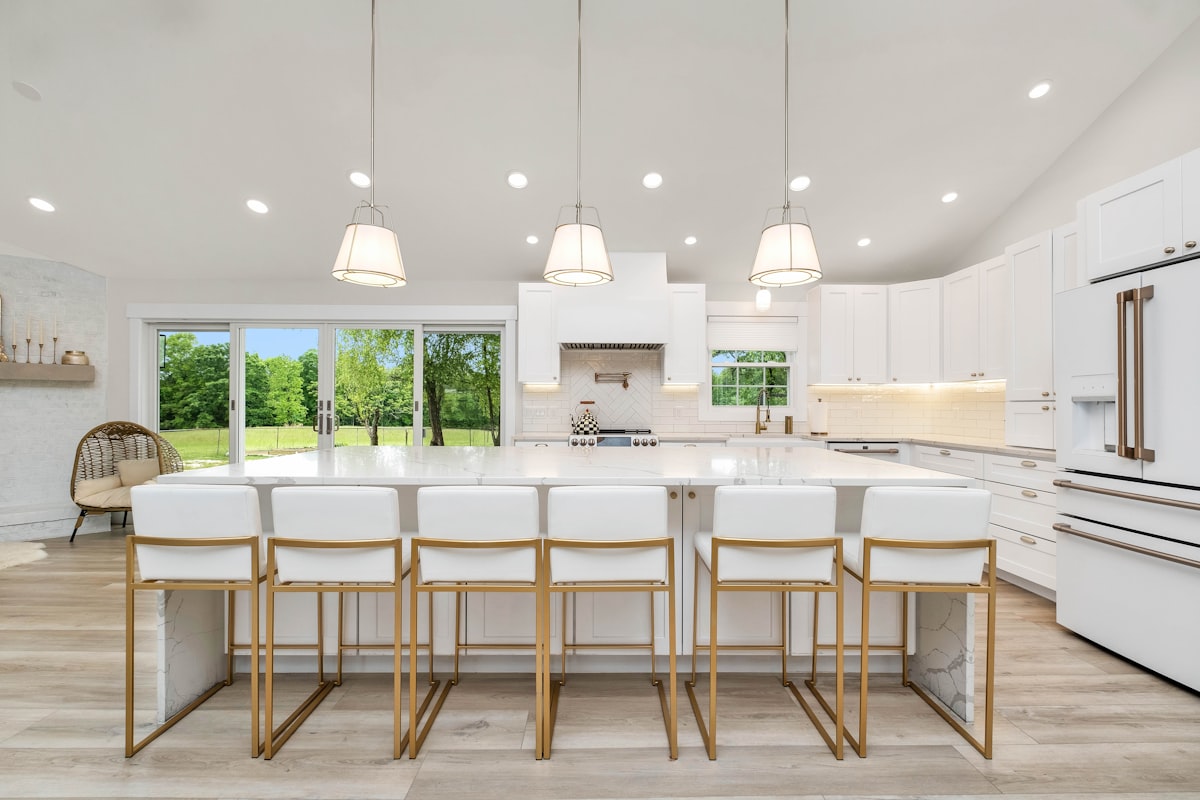 Modern kitchen with refaced white cabinets and new hardware after renovation