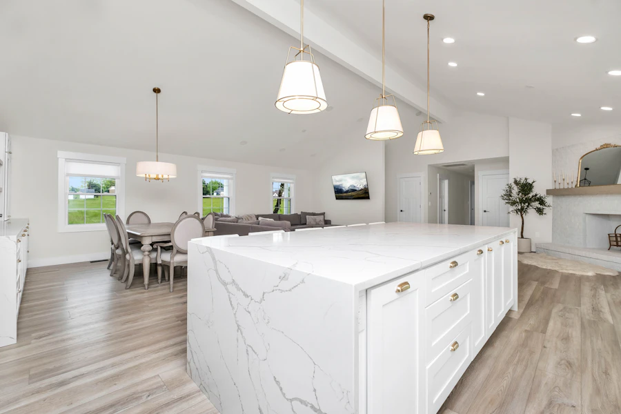 Large white kitchen with a marble island