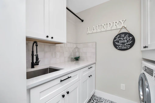 a laundry room with a sink and a washer and dryer