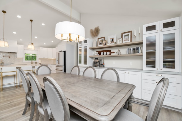 a large kitchen with a table and chairs in it