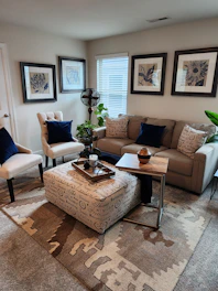 A cozy sectional sofa in navy blue with plush pillows and a chaise lounge.