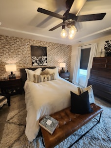 Bright and stylish bedroom featuring decorative cushions and wall art from Goldsolutions.