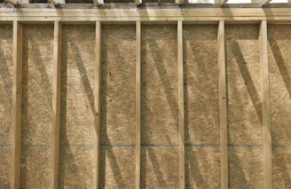 a man standing on top of a pile of wood