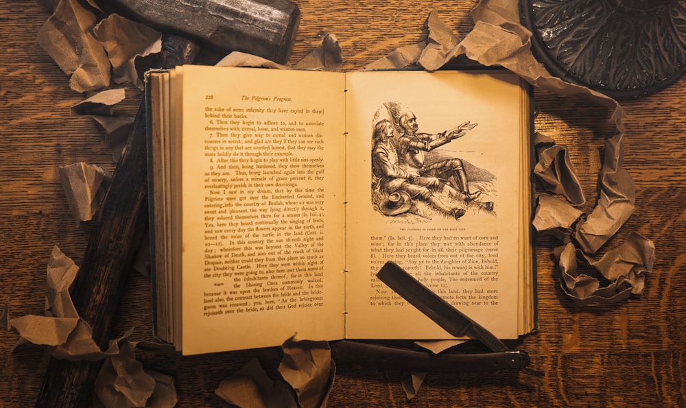 an open book sitting on top of a wooden table