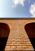 a brick wall with a sky in the background