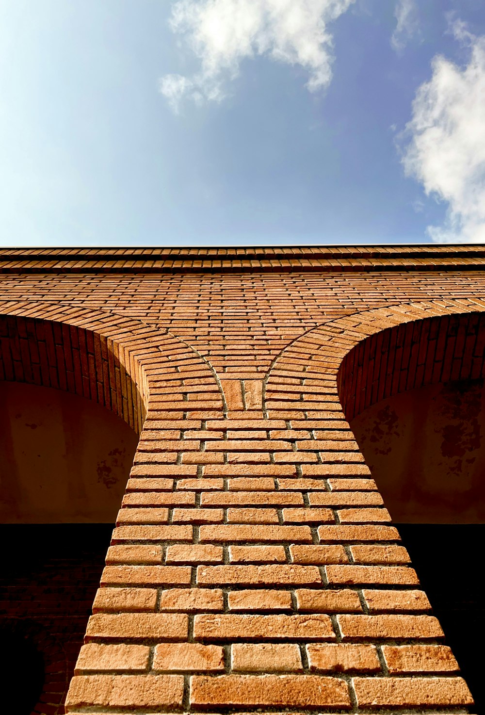 a brick wall with a sky in the background