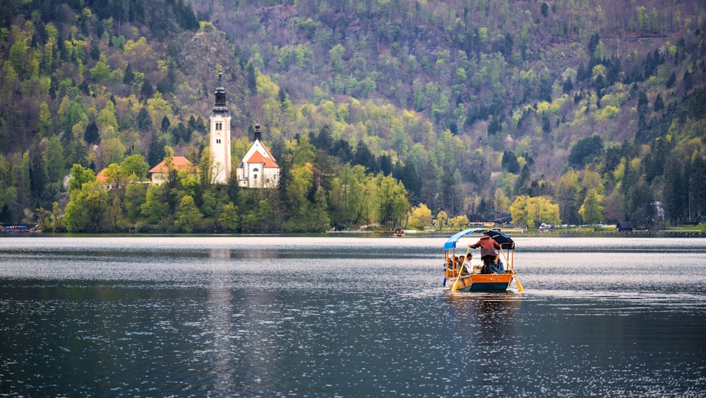 a boat with people on it in a lake