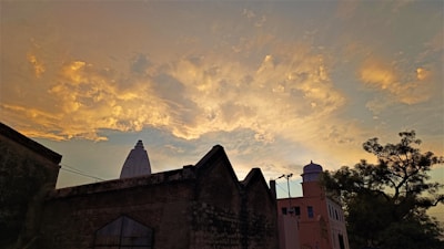 A serene architectural silhouette against a muted, warm stone sky at dusk.