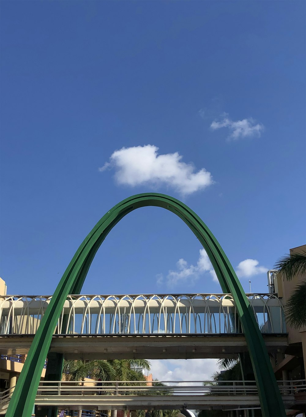 a very tall green arch with a sky background