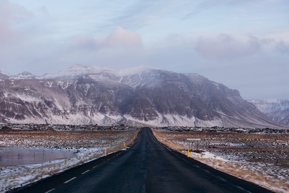 a long road with a mountain in the background