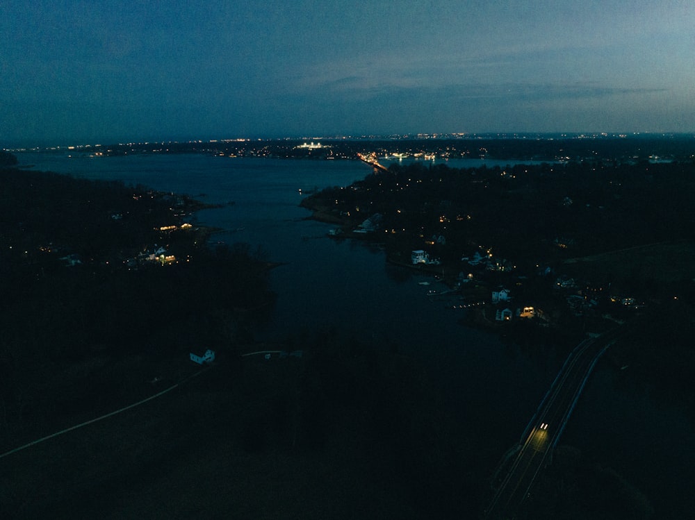 a view of a river at night from a hill