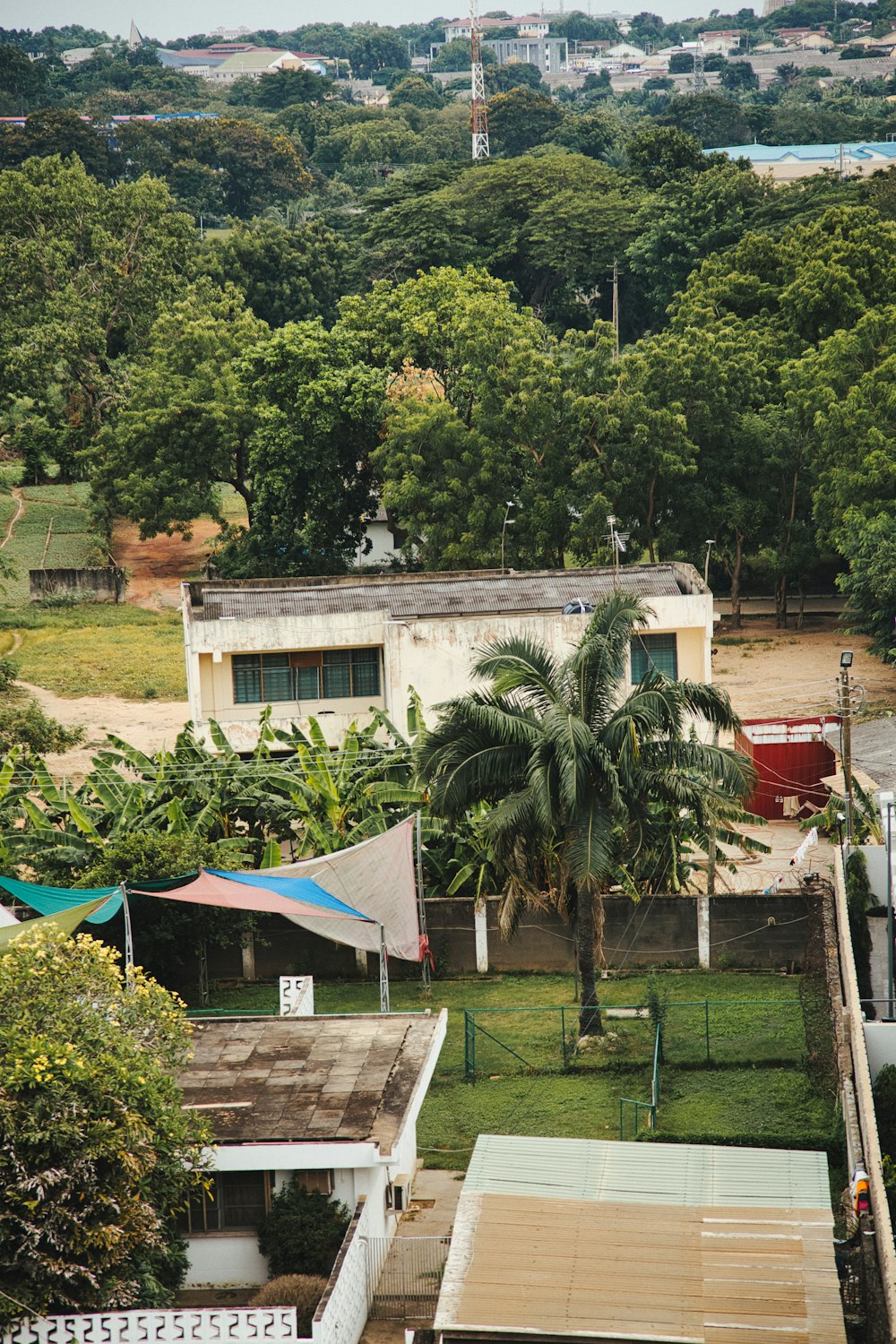 a view of some houses and trees from a hill