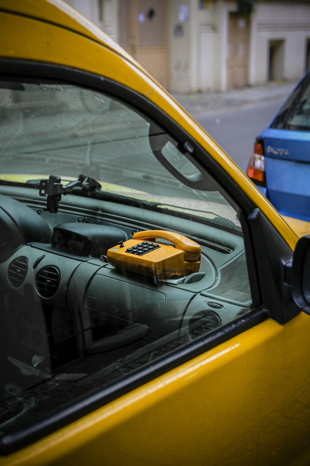 a yellow box sitting on the dashboard of a car