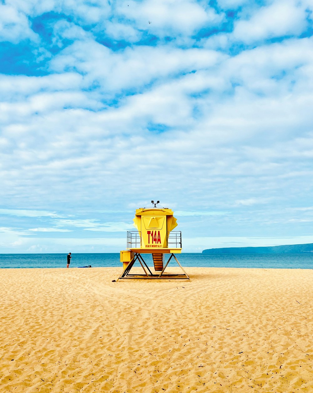 a lifeguard tower on a beach with a sky background