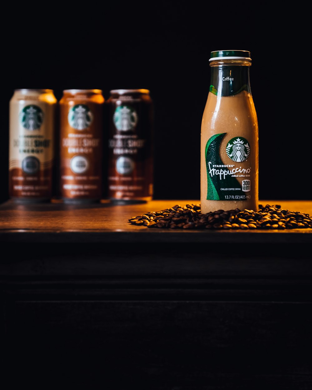 a bottle of starbucks coffee sitting on top of a table