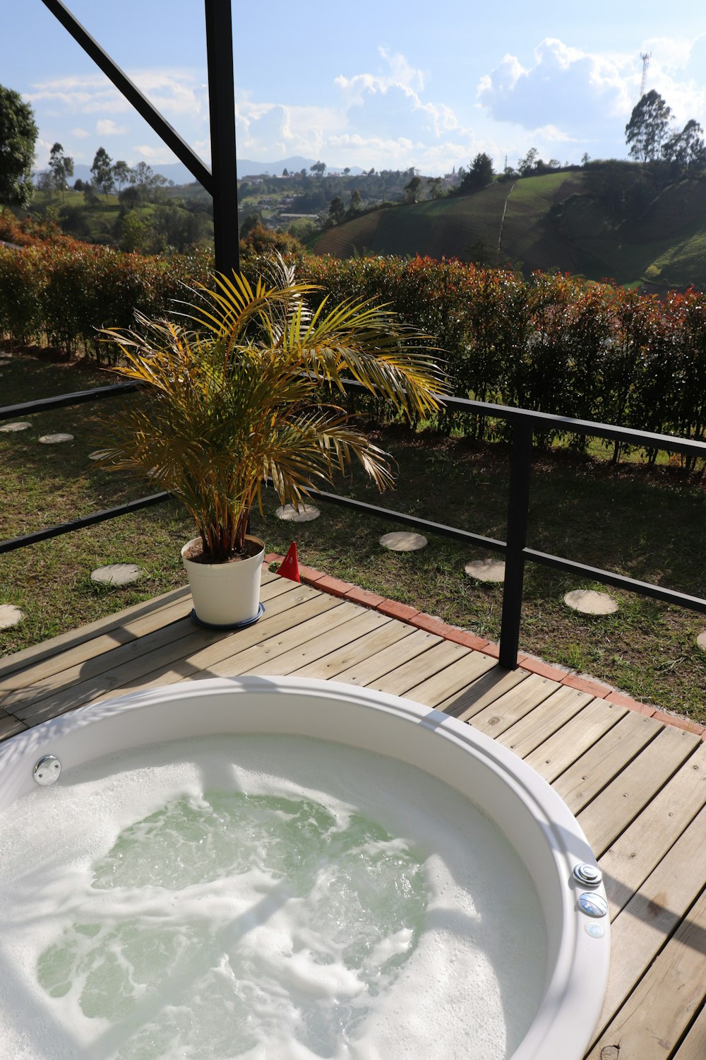 a large white tub sitting on top of a wooden deck