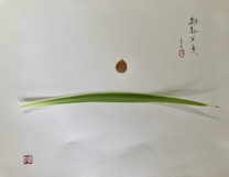 A minimalistic arrangement featuring a single long, green leaf placed horizontally, with a small brown leaf positioned above it on a plain white background. Chinese calligraphy in black ink is present on the upper right side, accompanied by a red stamp in the lower left corner.