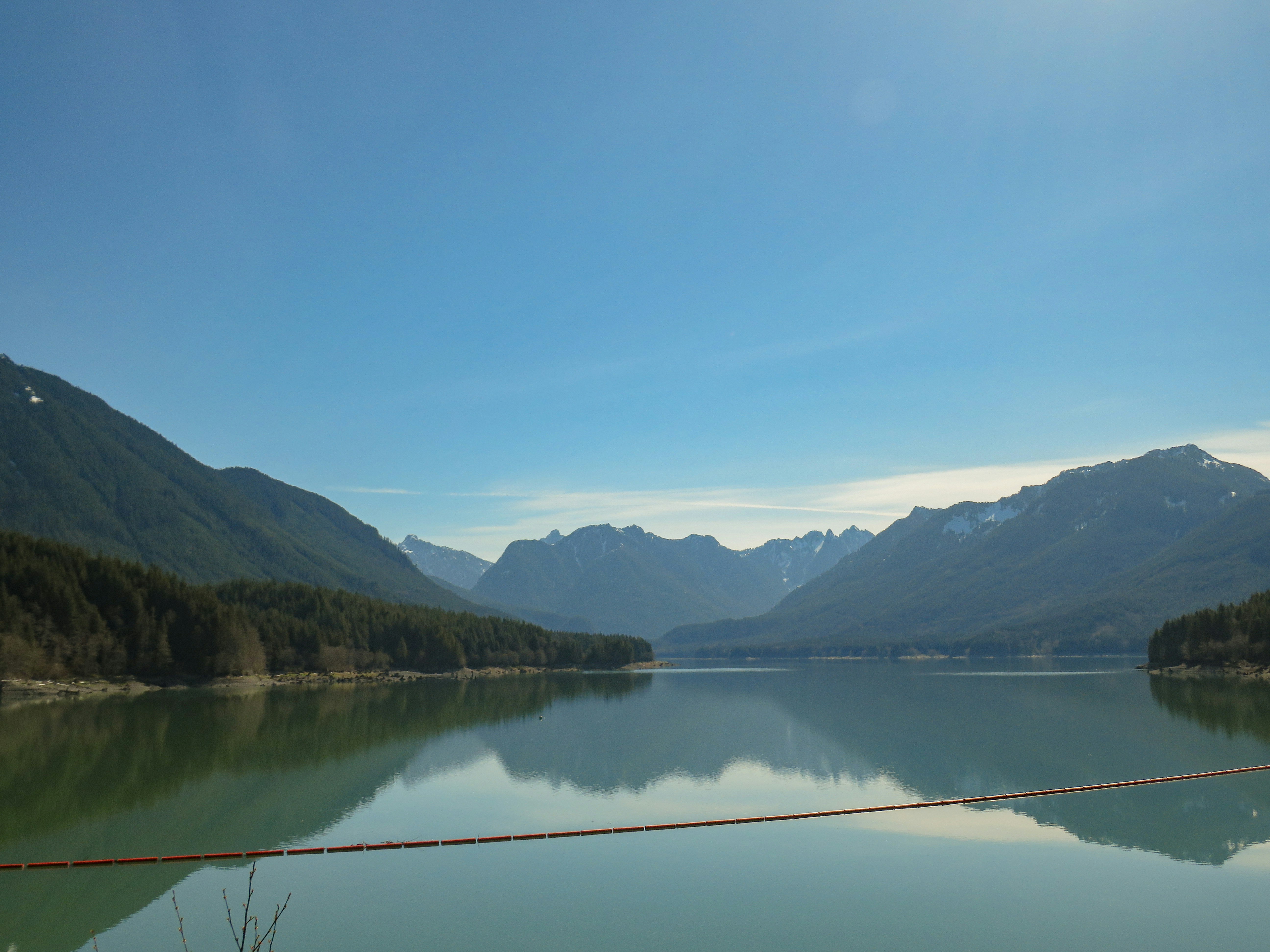 a body of water with mountains in the background
